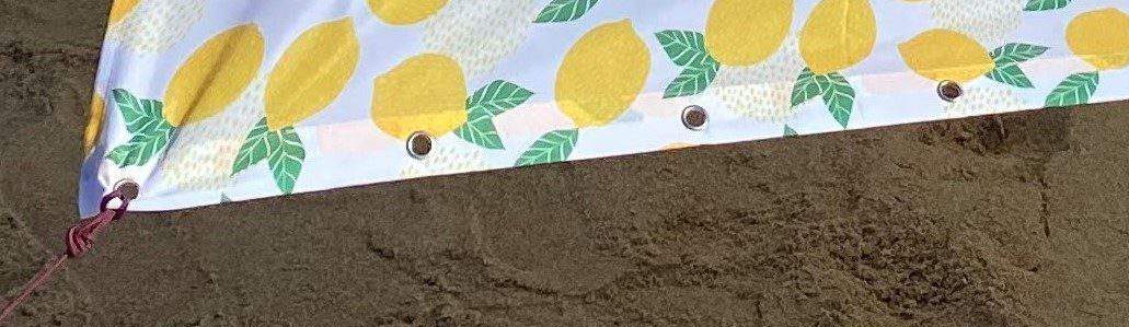 diy beach shade - close up of grommets along edge of a shower curtain